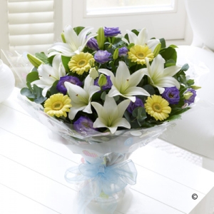 Featuring lemon germini, cream Asiatic lilies and purple lisianthus, hand-tied with salal and eucalyptus, wrapped and finished with a blue ribbon.