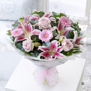 Featuring pink large-headed roses, pink germinis and pink lilies,  eucalyptus and salal, all hand-tied and finished with new baby gift wrapping.