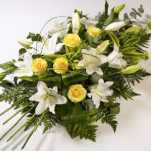 Beautiful yellow roses presented with white oriental lilies.