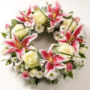 Pink lilies combined with elegant cream roses