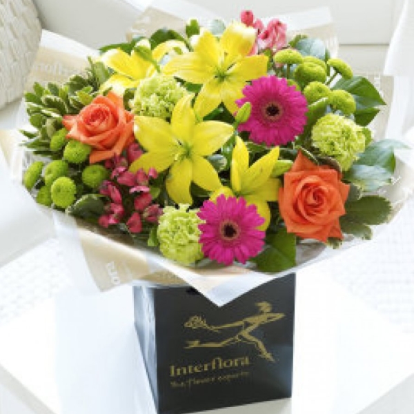 aA vibrant selection of roses, lily, germini, caranations, chrysanths and alstromaria.